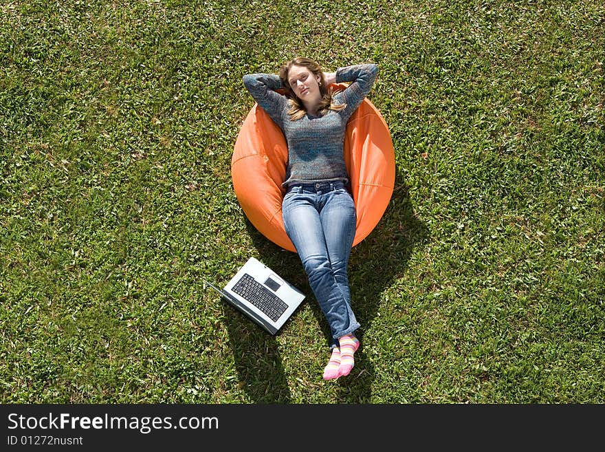 Beautiful woman working out sitting on orange puff