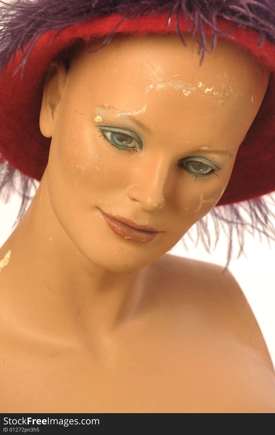 Old mannequin is wearing red hat. Old mannequin is wearing red hat