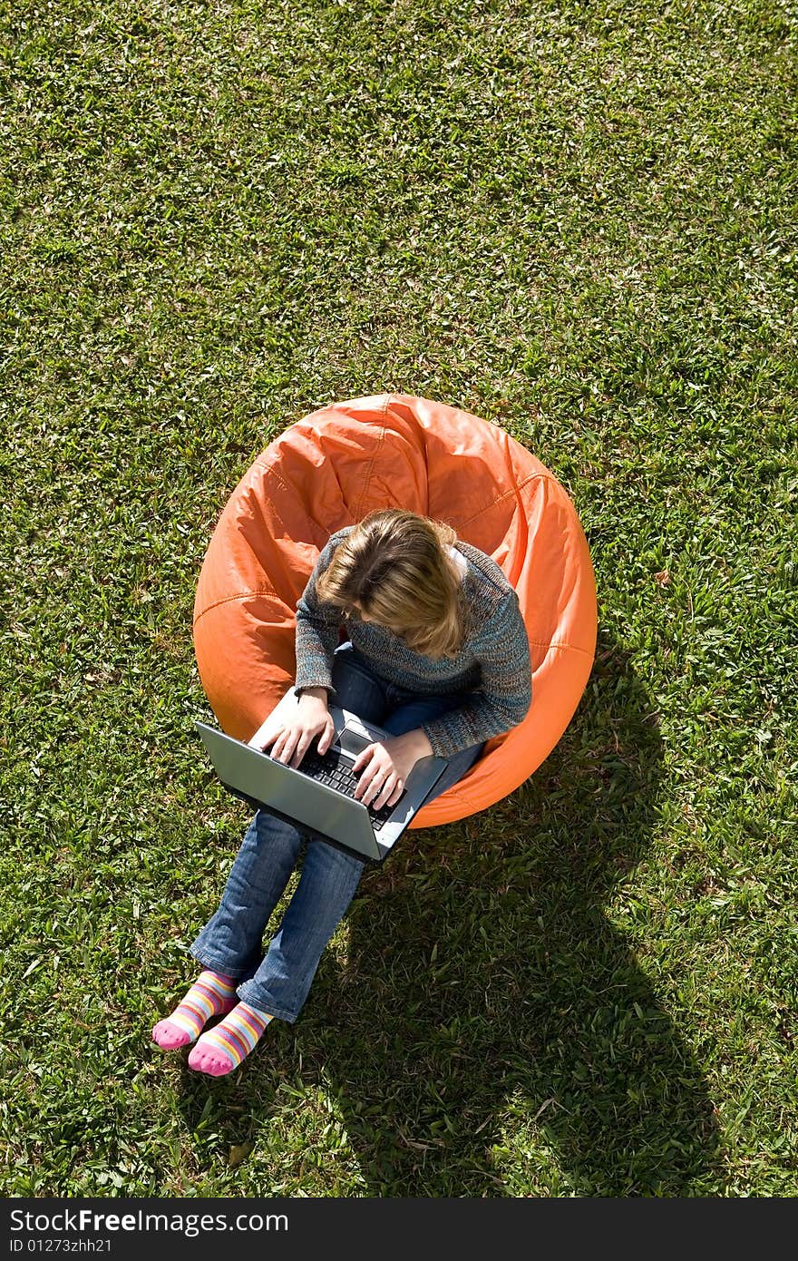 Beautiful woman working out sitting on orange puff