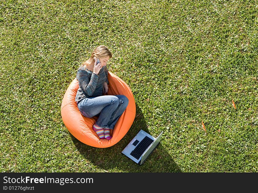 Beautiful woman working out sitting on orange puff