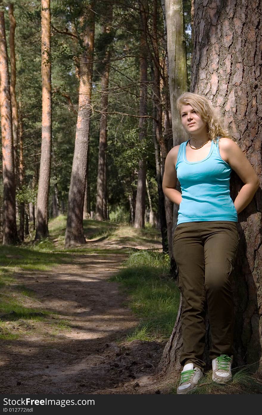 Young beautiful woman in a summer wood