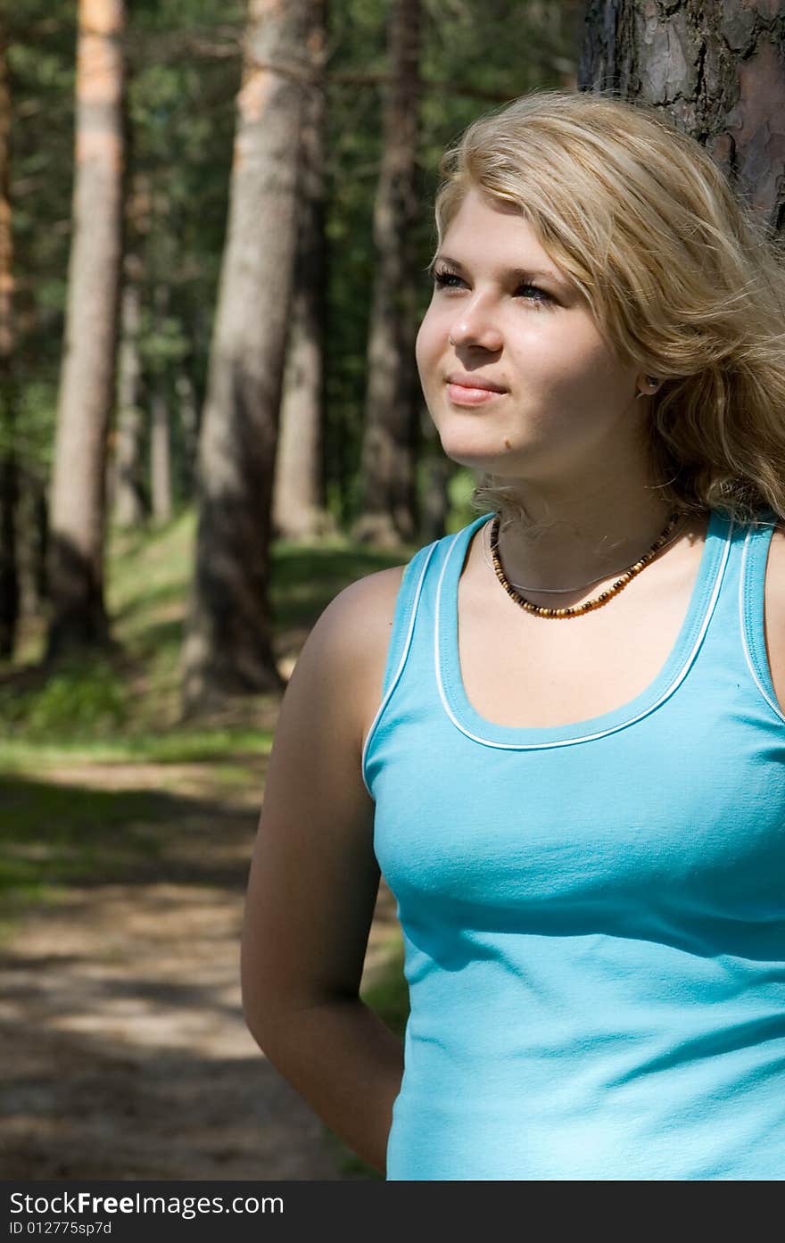 Young beautiful woman in a summer wood