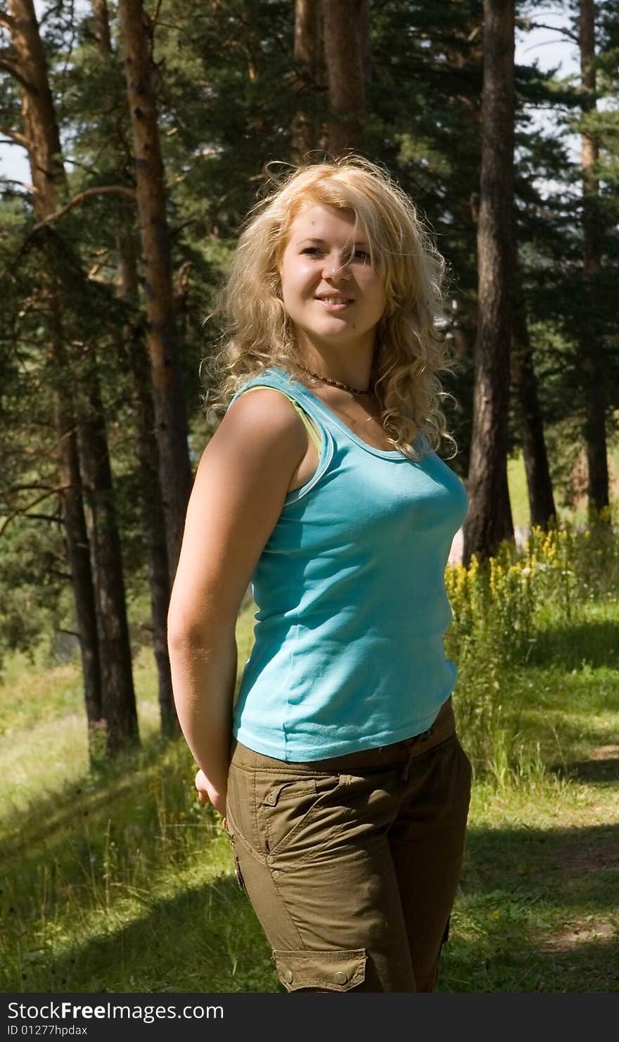 Young beautiful model in a summer wood