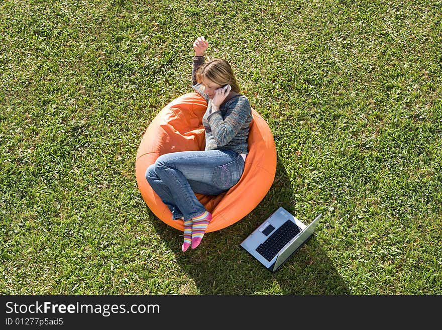 Beautiful woman working out sitting on orange puff