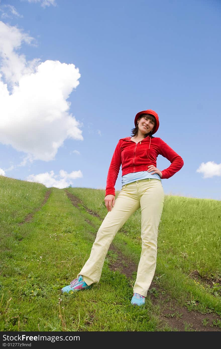 Happy young girl standing on the hill