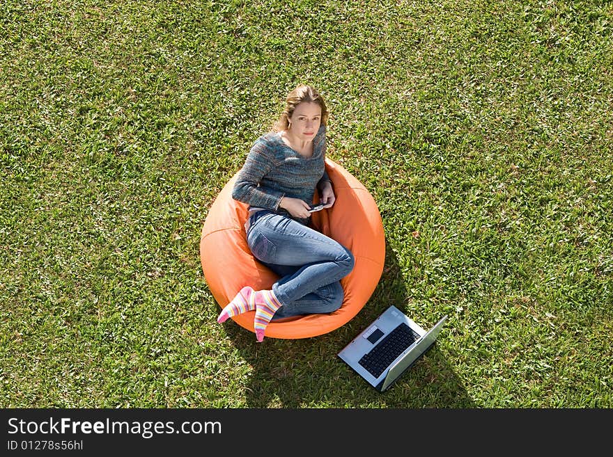 Beautiful woman working out sitting on orange puff