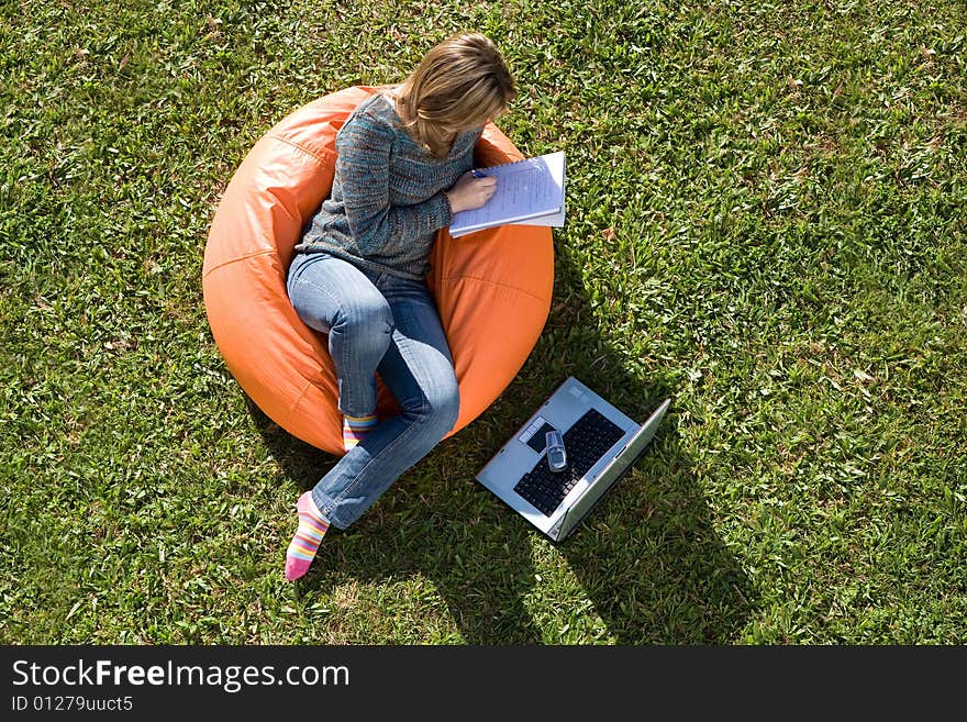 Beautiful woman working out sitting on orange puff