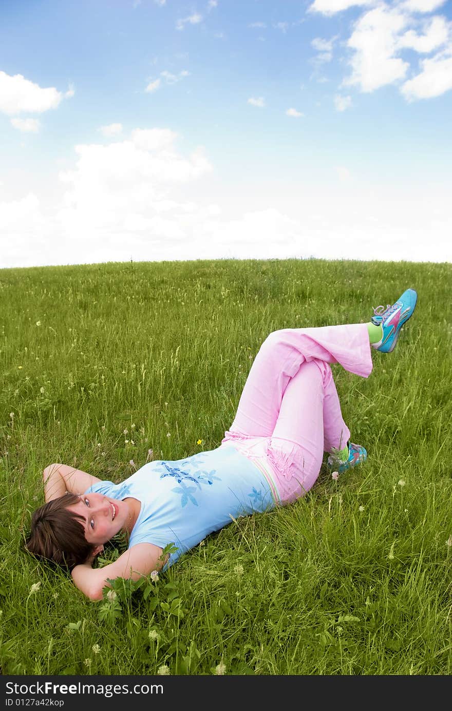 Pretty girl relaxing girl outdoor on the grass