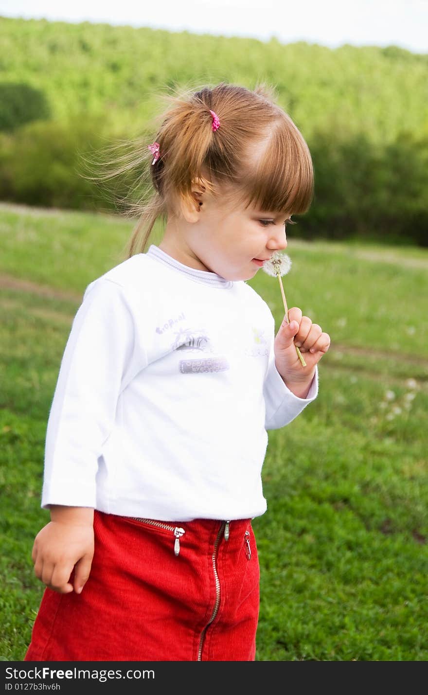 Girl Blowing At The Dandelion