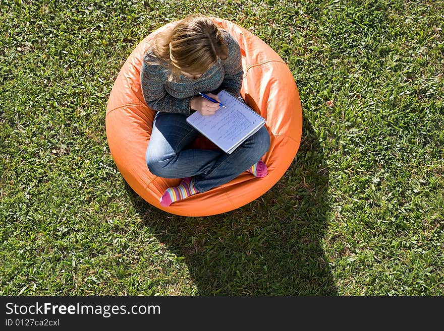 Beautiful woman working out sitting on orange puff