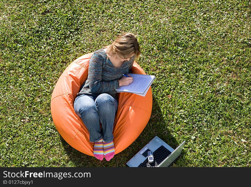 Beautiful woman working out sitting on orange puff