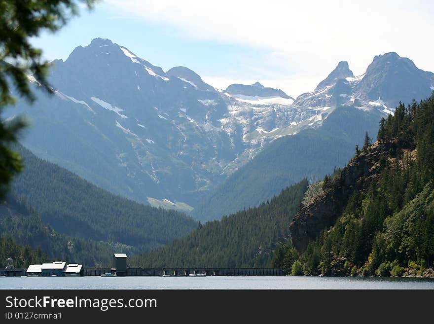 Mountain range framed by a valley with the top of a dam along the bottom. Mountain range framed by a valley with the top of a dam along the bottom