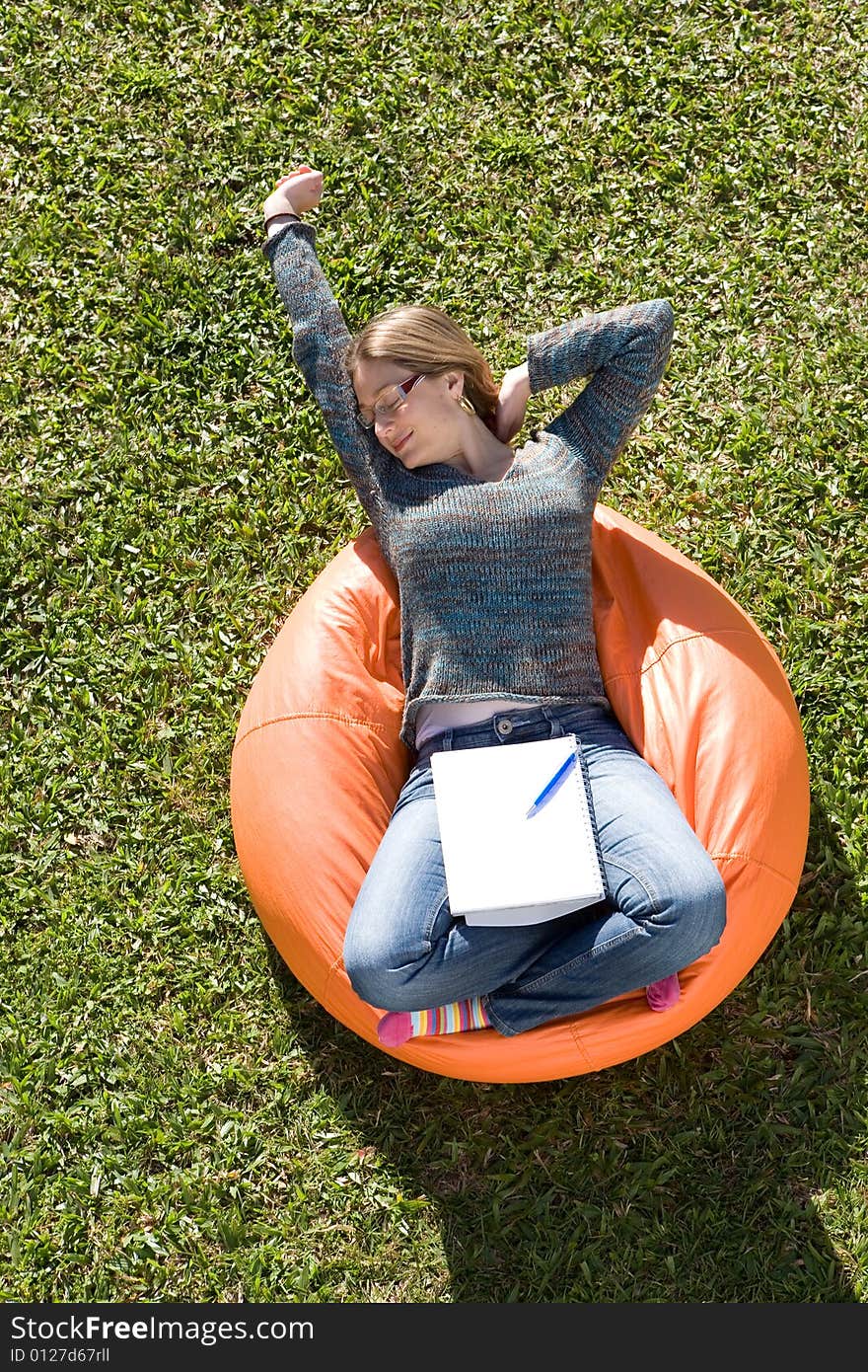 Beautiful woman working out sitting on orange puff