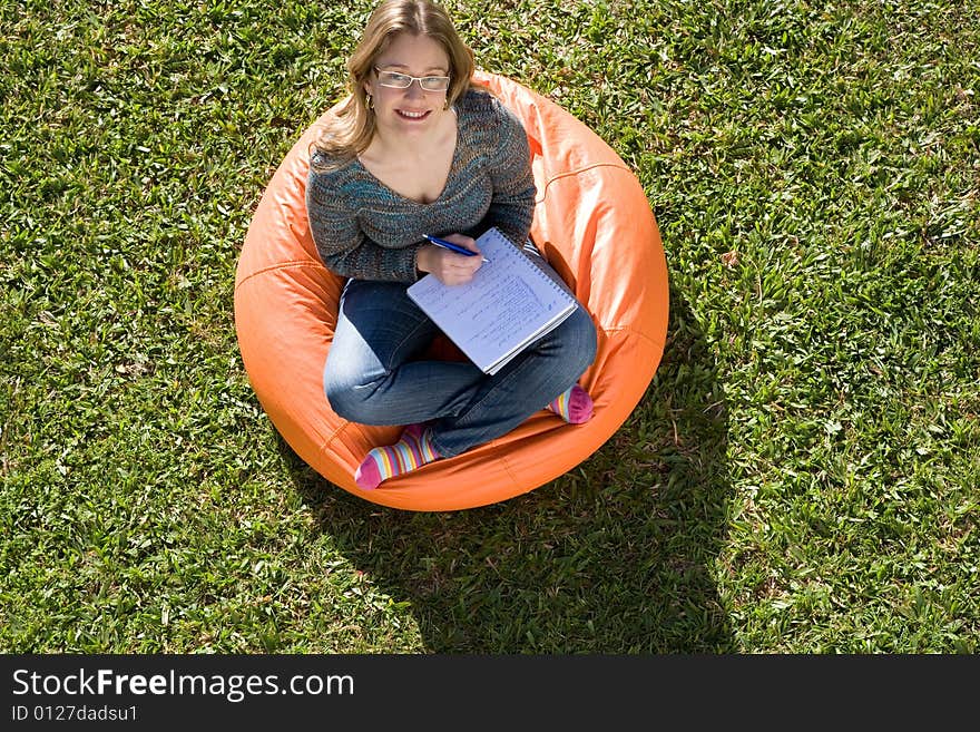 Beautiful woman working out sitting on orange puff