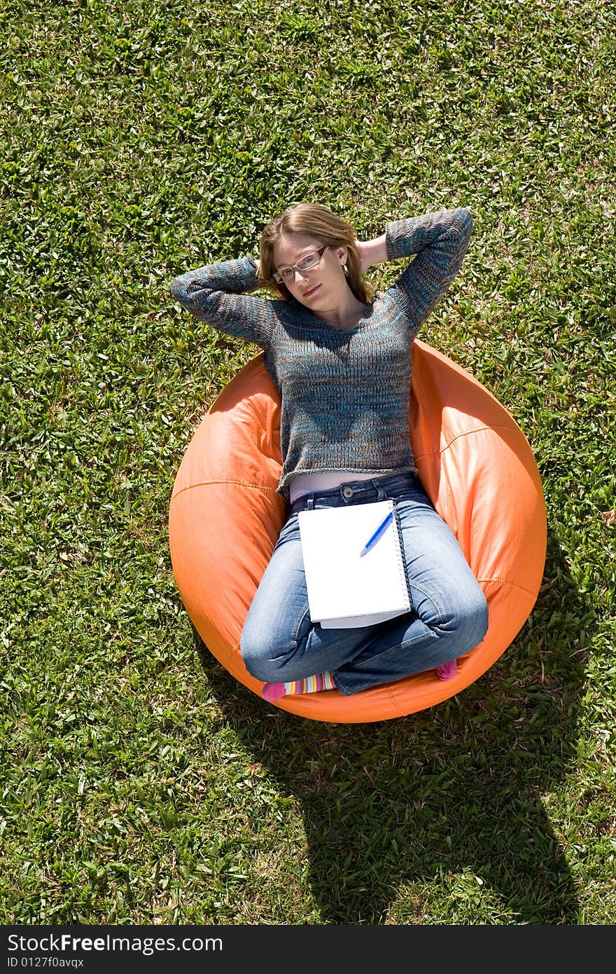 Beautiful woman working out sitting on orange puff