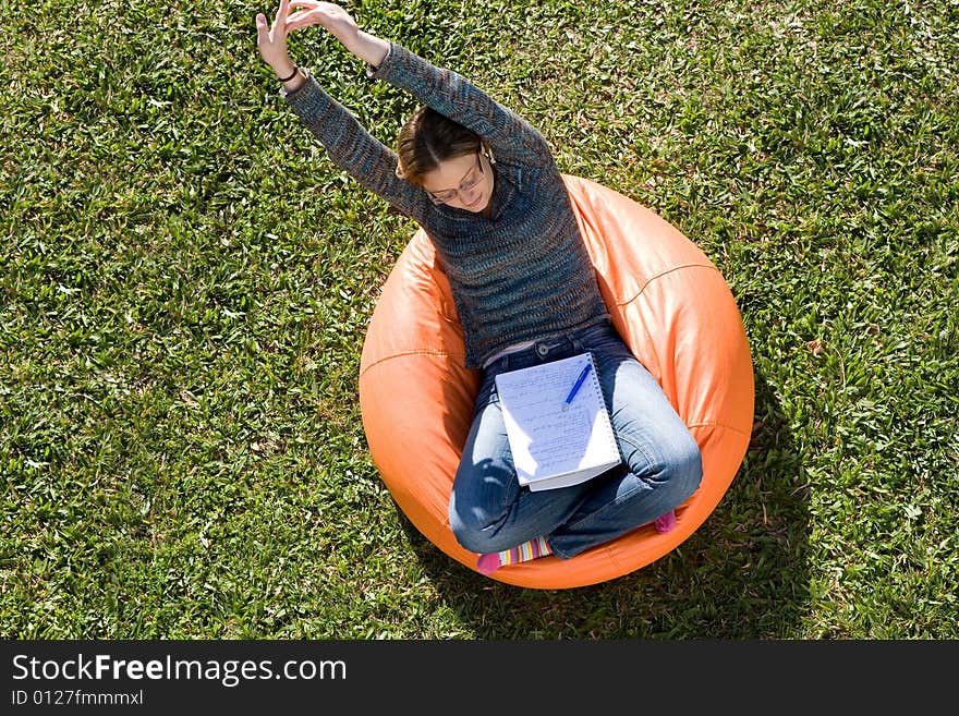 Beautiful woman working out sitting on orange puff