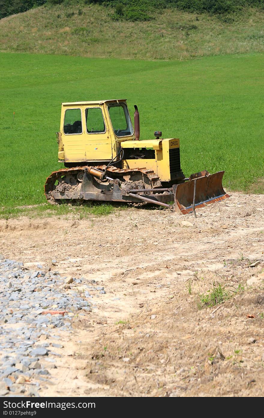 Photo of the yellow bulldozer on the timber line - Beskid mountains