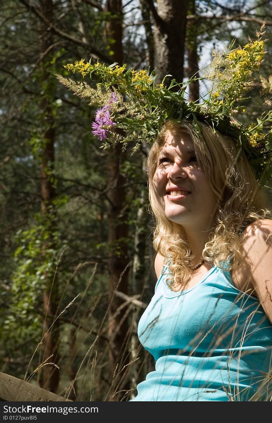 Young beautiful woman in a summer wood