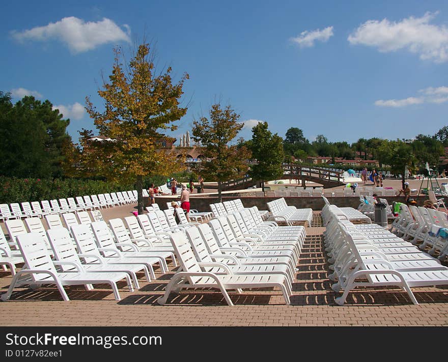 A row of empty pool chairs.