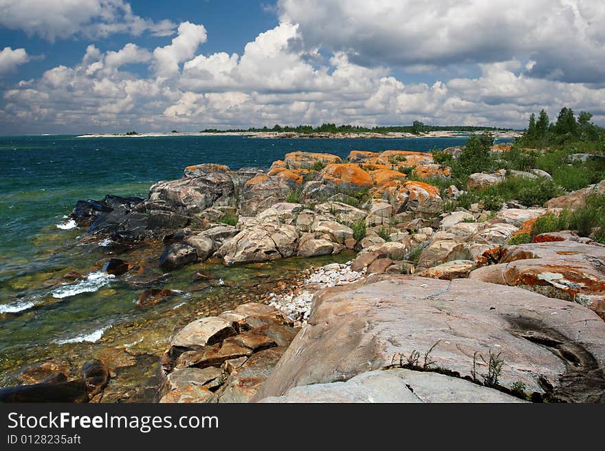 Rocky island on a lake with dramatic sky. Georgian Bay, Ontario, Canada. Rocky island on a lake with dramatic sky. Georgian Bay, Ontario, Canada