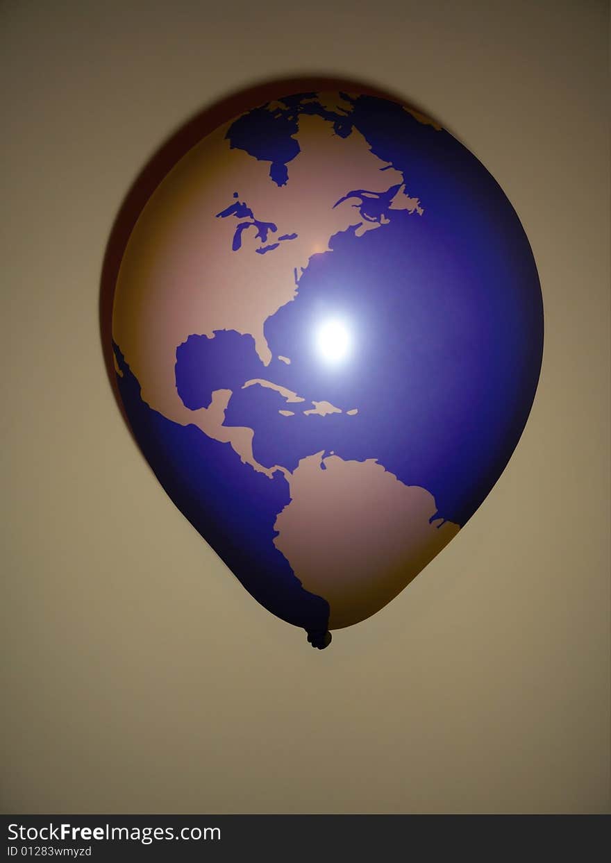 Photo of a balloon with an illustration of the earth on its surface. Photo of a balloon with an illustration of the earth on its surface