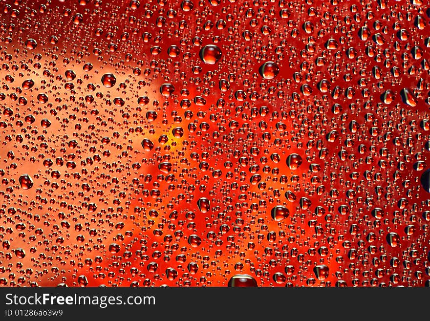 Drops of water on a red background. Drops of water on a red background.