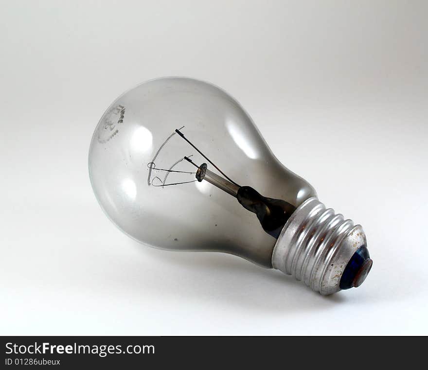 Close-up of a burnt light bulb on white background