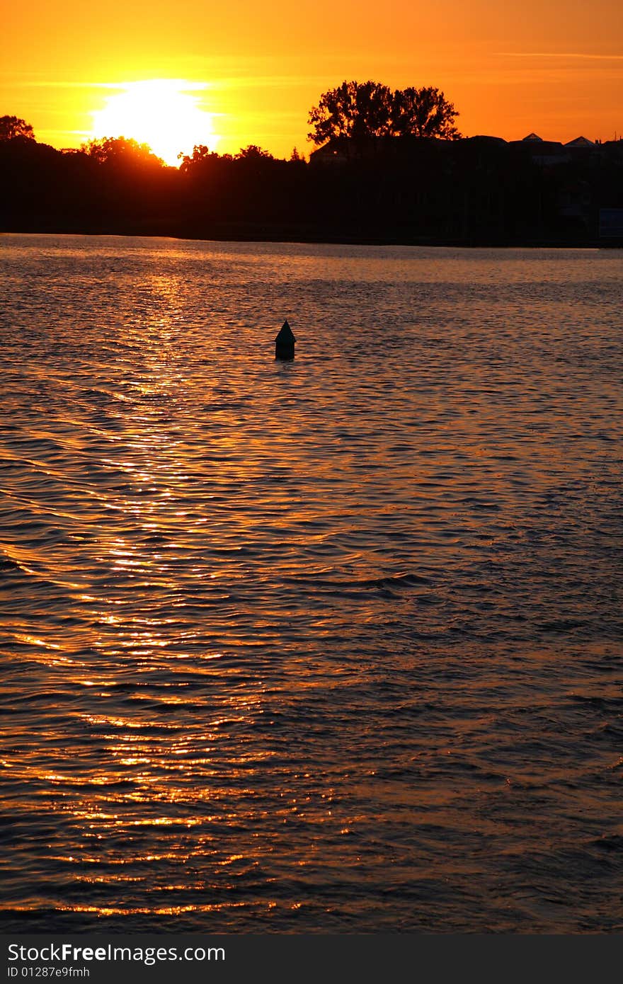 Buoy In Lake Over Sunset