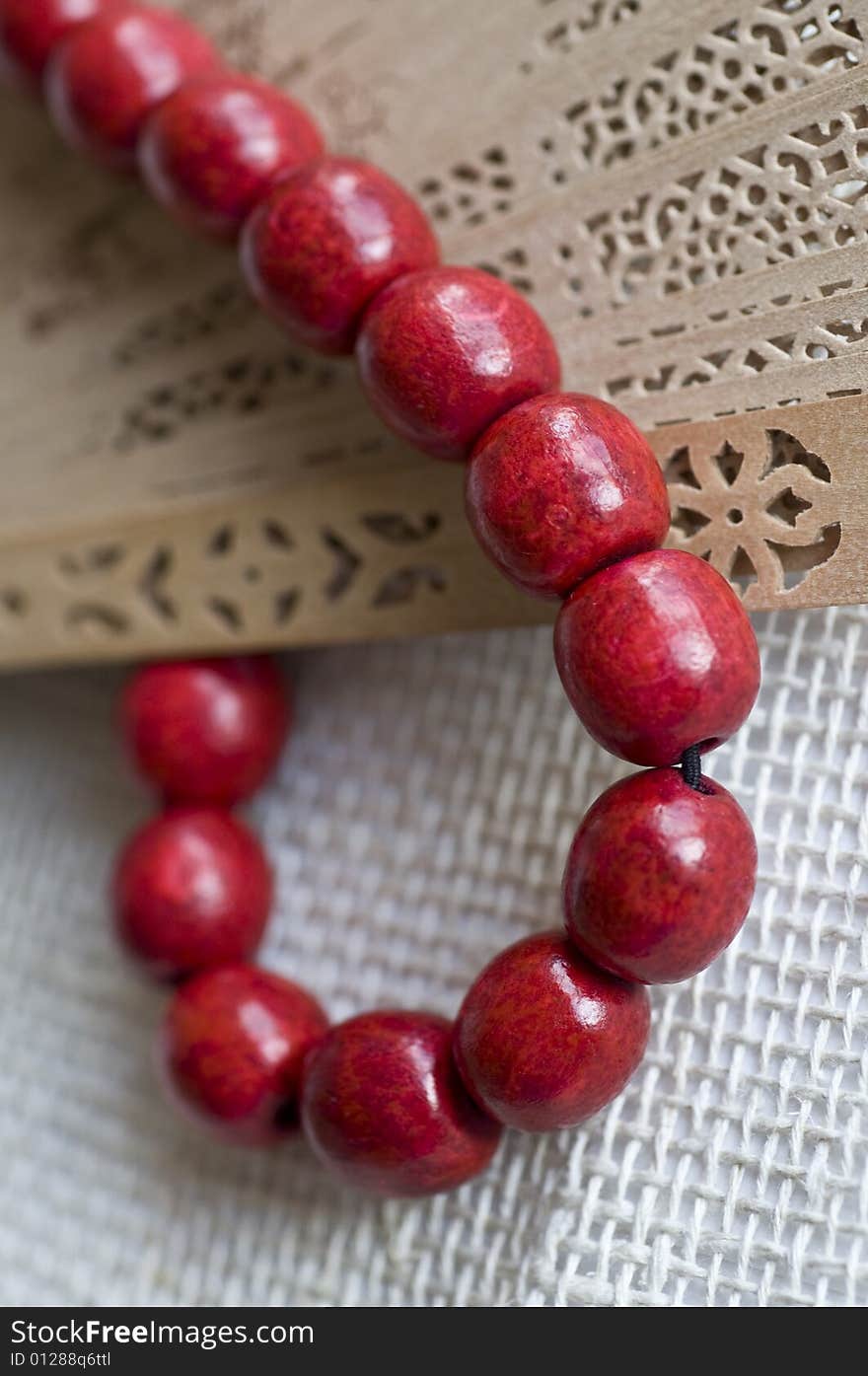 Red wooden beads with a fan. Red wooden beads with a fan