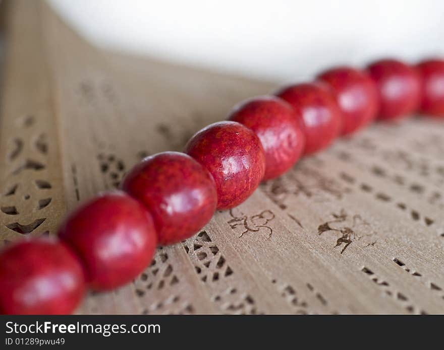 Red wooden beads with a fan. Red wooden beads with a fan