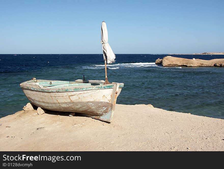 Old rowing boat on the sea-shore. Old rowing boat on the sea-shore