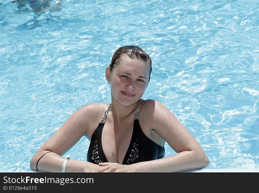 The lady in swimming pool in summer. The lady in swimming pool in summer