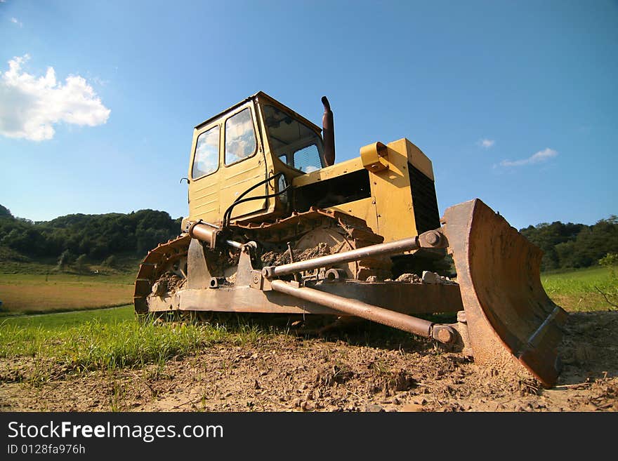 Photo of the yellow bulldozer on the timber line - Beskid mountains