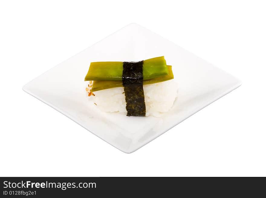 A square white plate with a piece of sushi