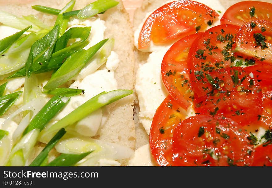 Slices of mozzarella, tomatoes and spring onion over freshly baked ciabatta. Slices of mozzarella, tomatoes and spring onion over freshly baked ciabatta.