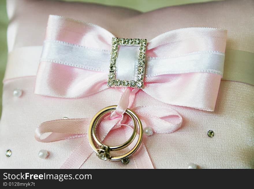 Wedding rings on the pink material