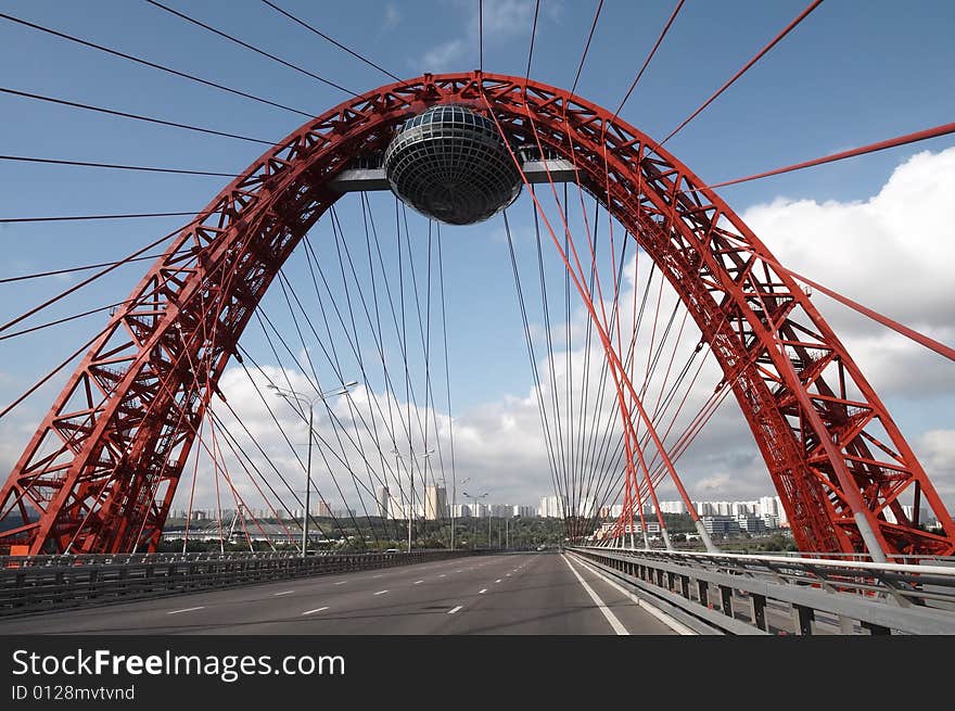 Modern bridge on cloudy sky