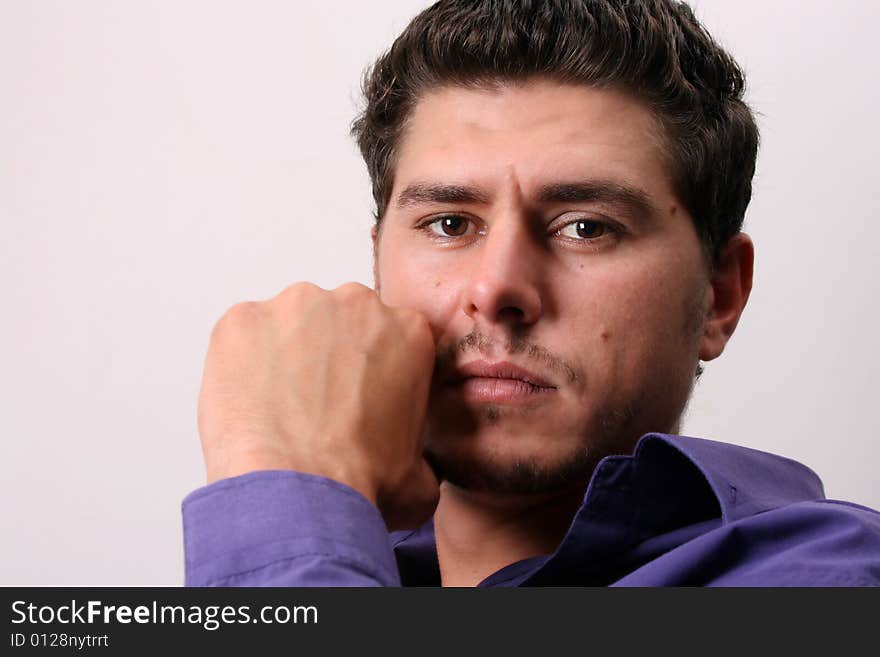 Male model in studio against white wall