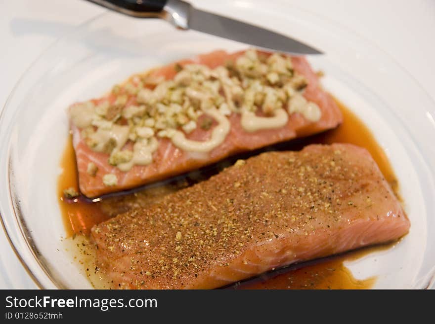 Two salmon fillets prepared with different sauces. Two salmon fillets prepared with different sauces