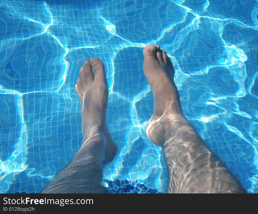 Man's Feet Underwater in Swimming Pool. Man's Feet Underwater in Swimming Pool