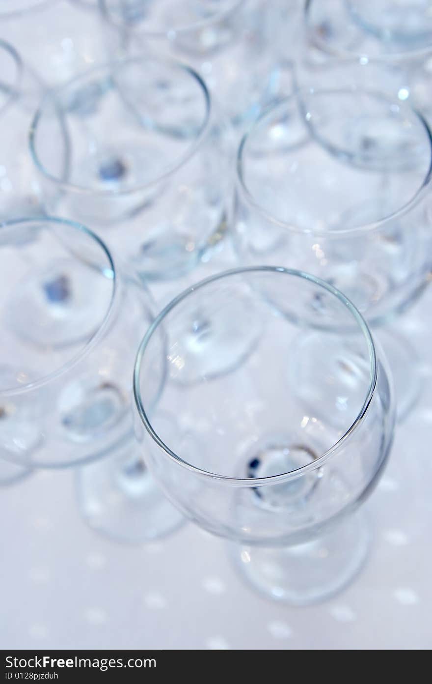 Empty glasses on a diagonal on a white cloth