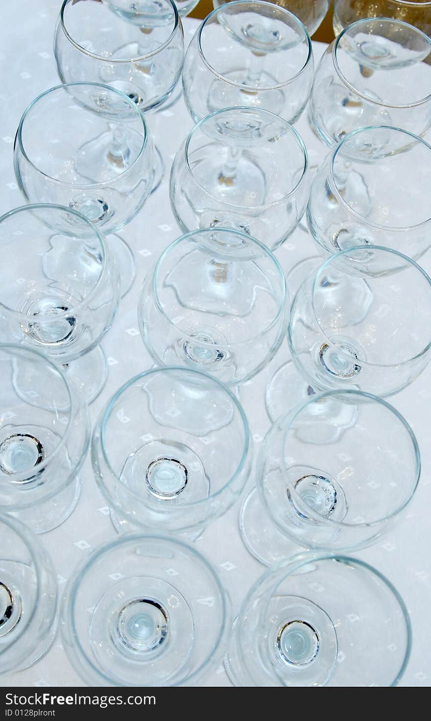 Empty glasses on a diagonal on a white cloth