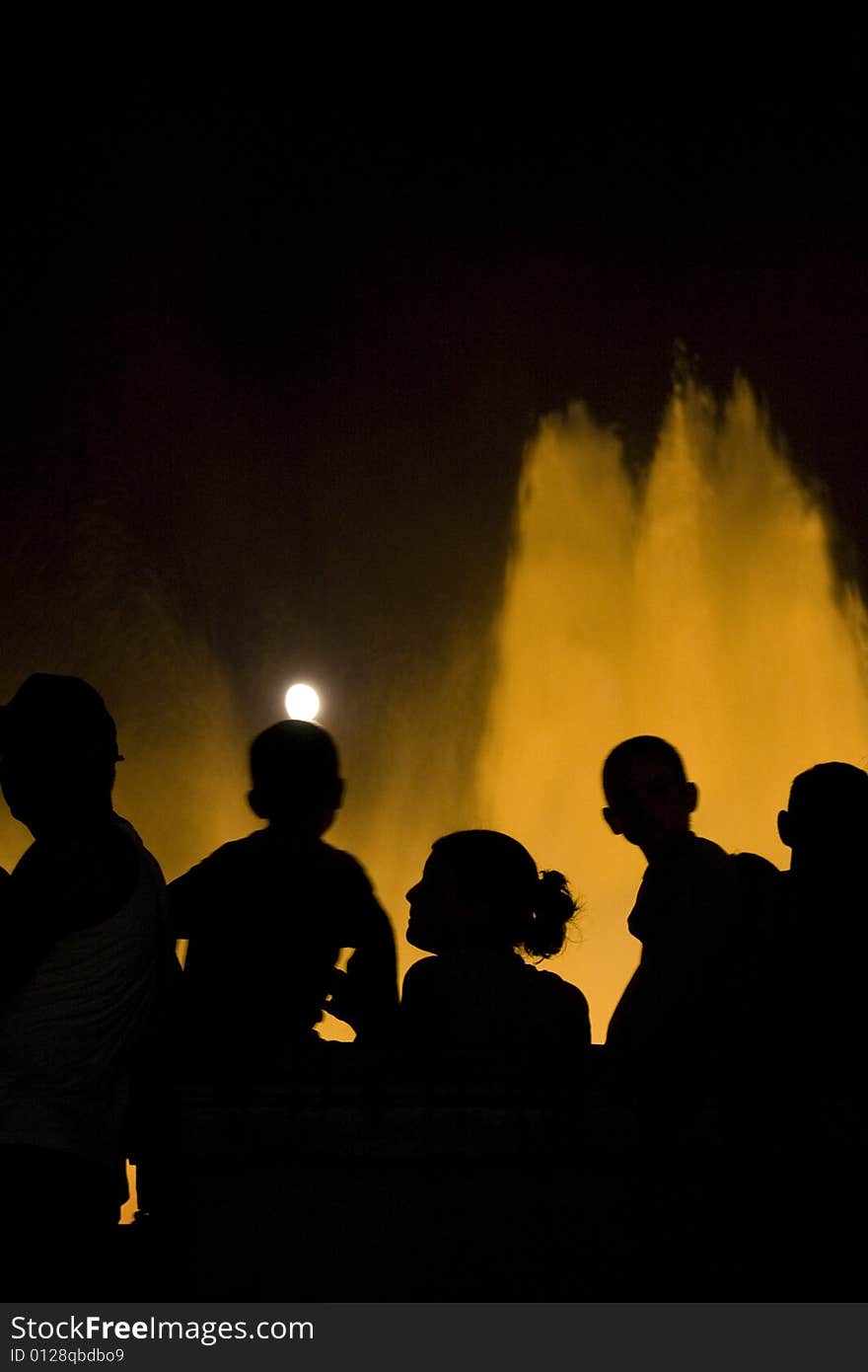 A family watching the fountain water show. A family watching the fountain water show