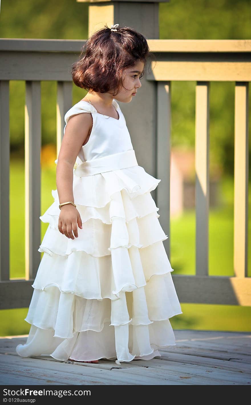 Shot of a two year old in a long white princess dress. Shot of a two year old in a long white princess dress.