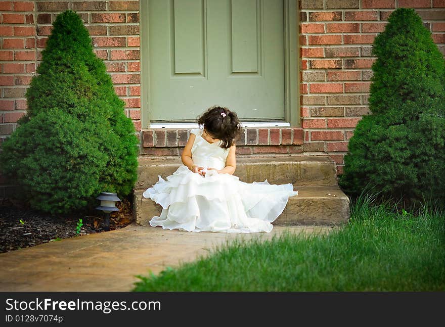 Shot of a two year old in a long white princess dress. Shot of a two year old in a long white princess dress.