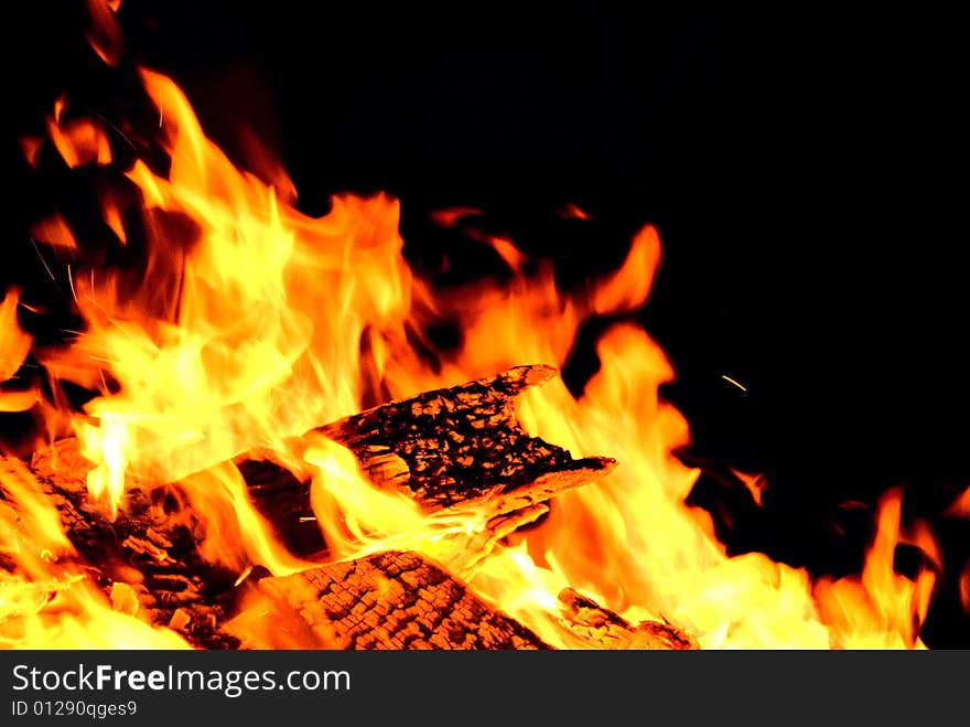 A picture of a burning piece of wood. A picture of a burning piece of wood