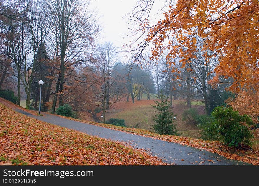 Autumn park, rain falling leaves and lanterns