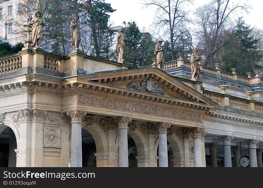 Stone children play on the roof of old building with columns