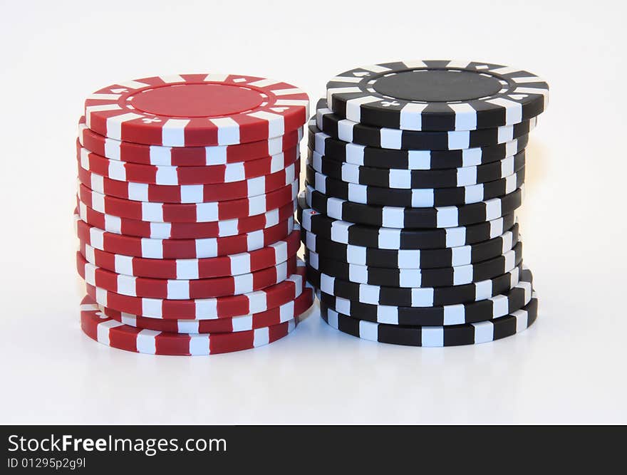 2 stacks of black and red poker chips isolated.