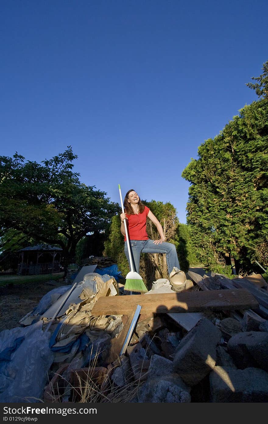 Woman Sweeping Through Garbage - Vertical